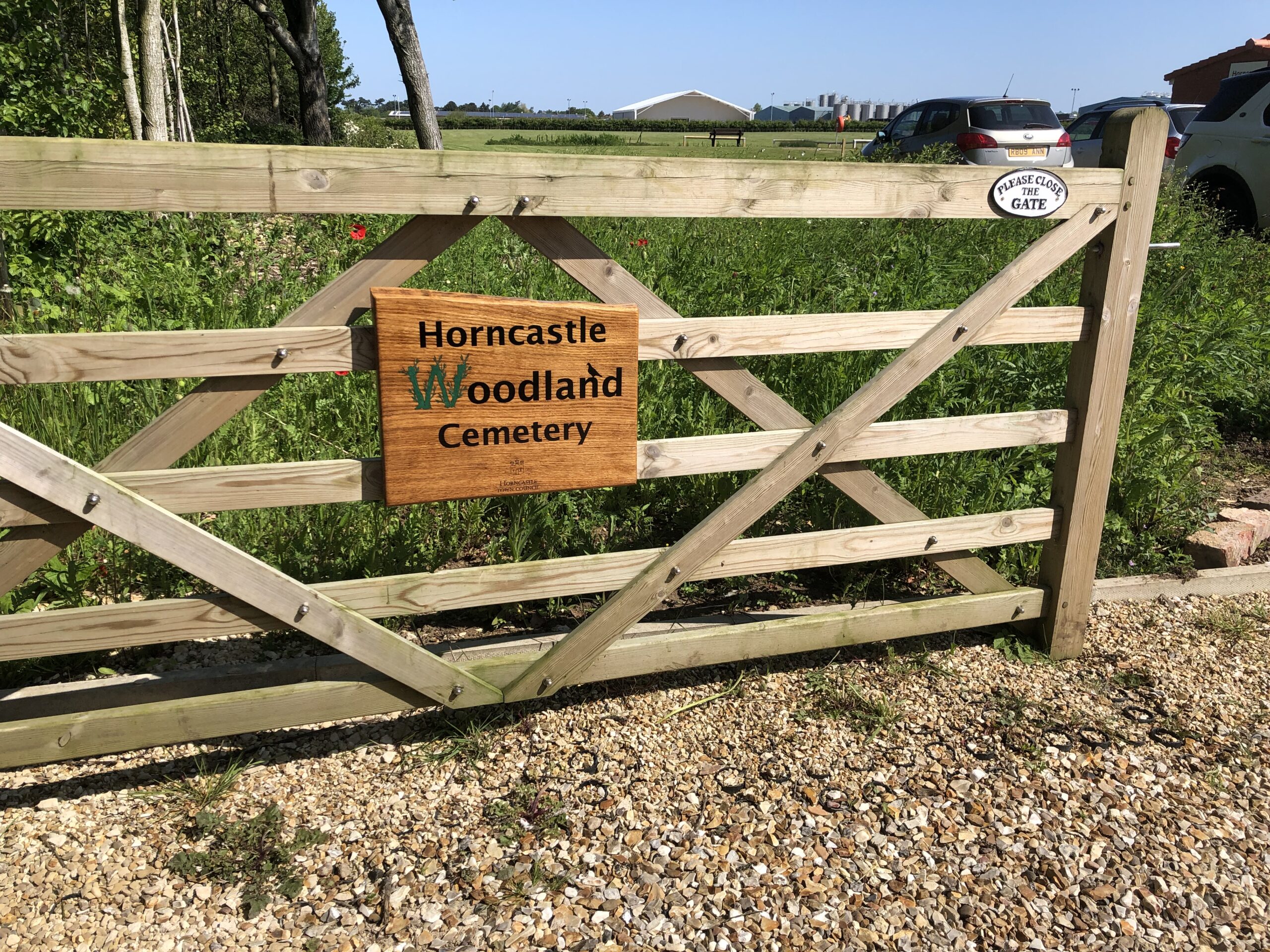Image of gate with handmade wooden sign at Horncastle Woodland Cemetery